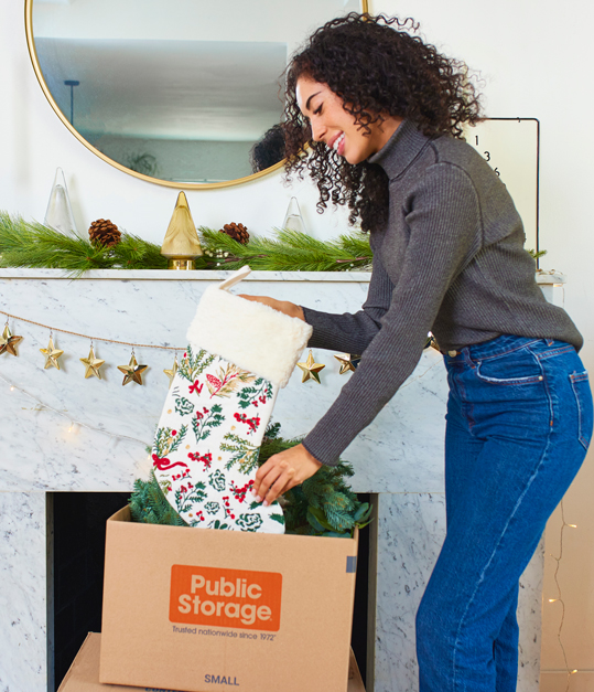 woman putting seasonal decor in storage