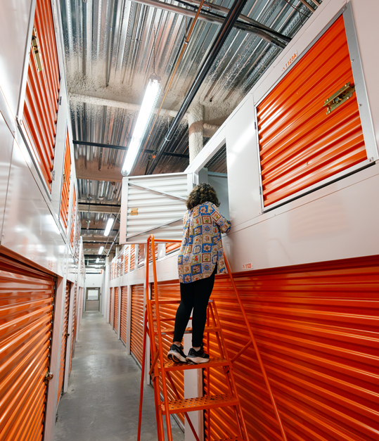 young woman moving items into storage lockers