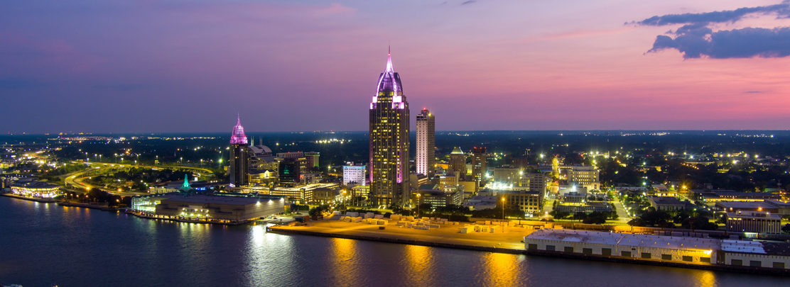 downtown mobile skyline at dusk